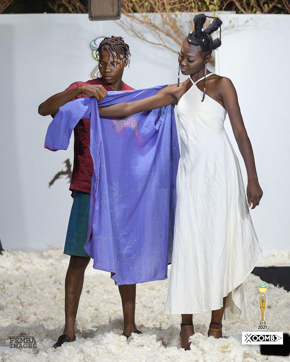 Models wearing Xoomba attire, including a purple shawl and white dress