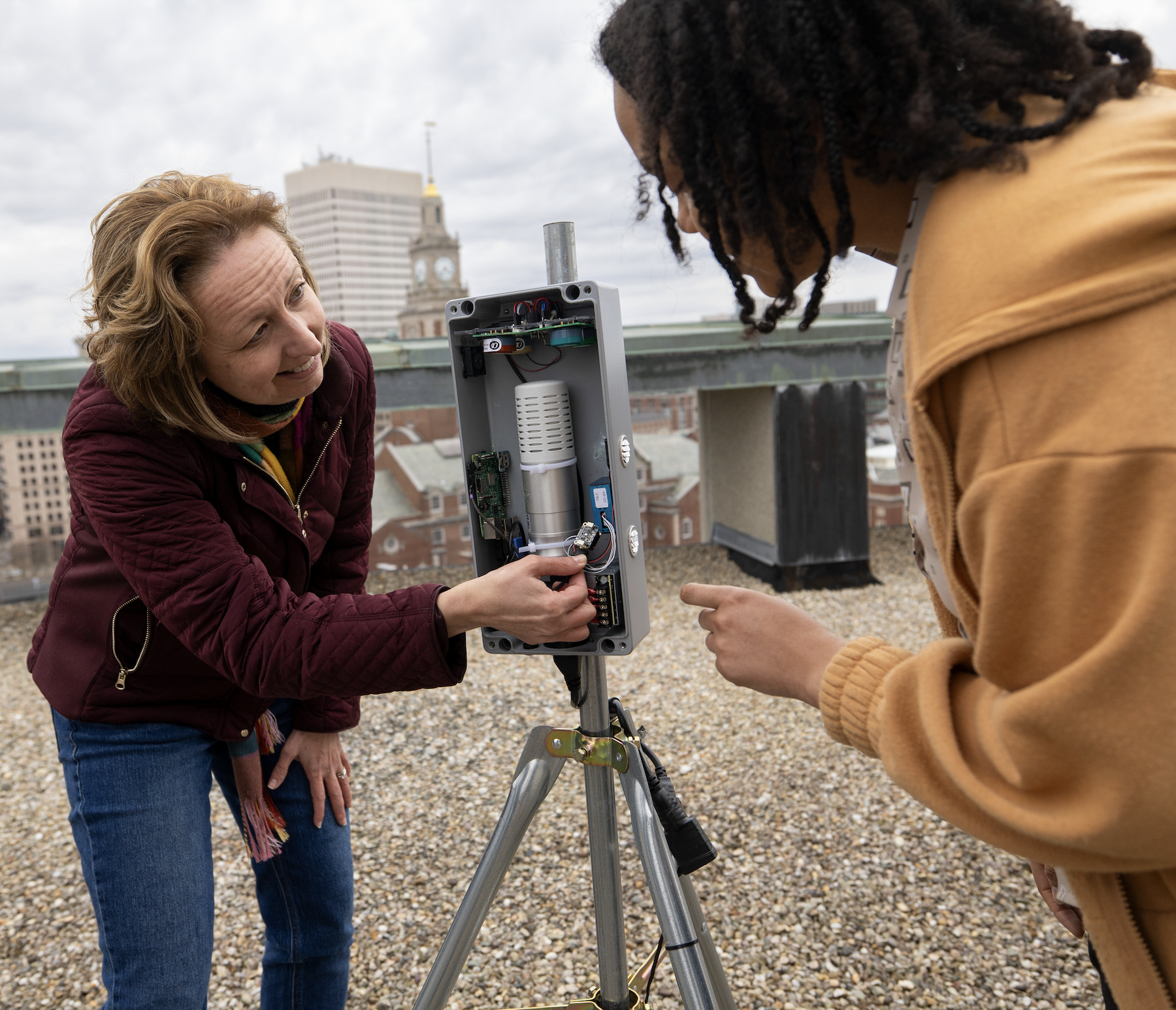 meredith and a student investigate an air monitor