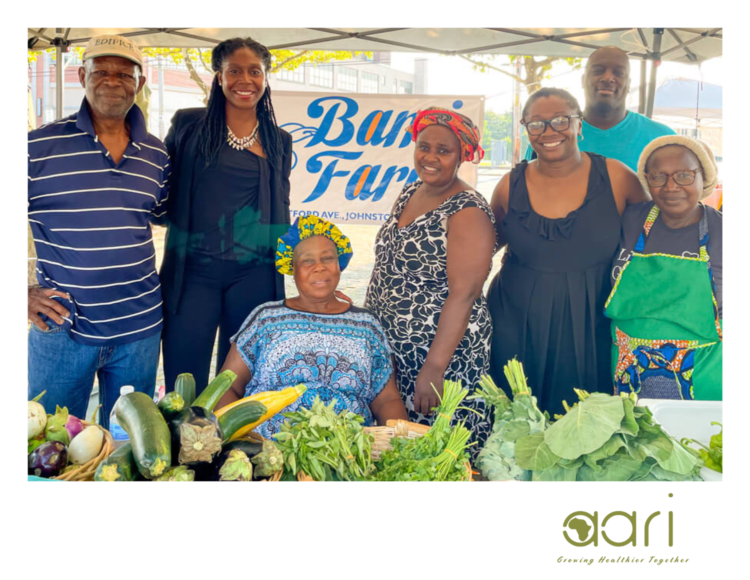 Members of the African Alliance of Rhode Island gather for a group photo at a farmers' market.