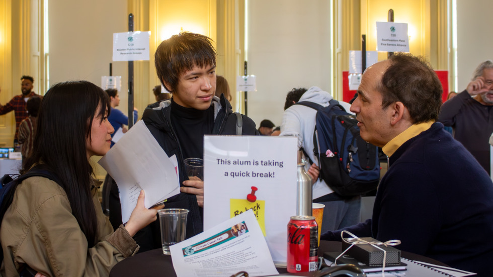 Students speak to an alumnus