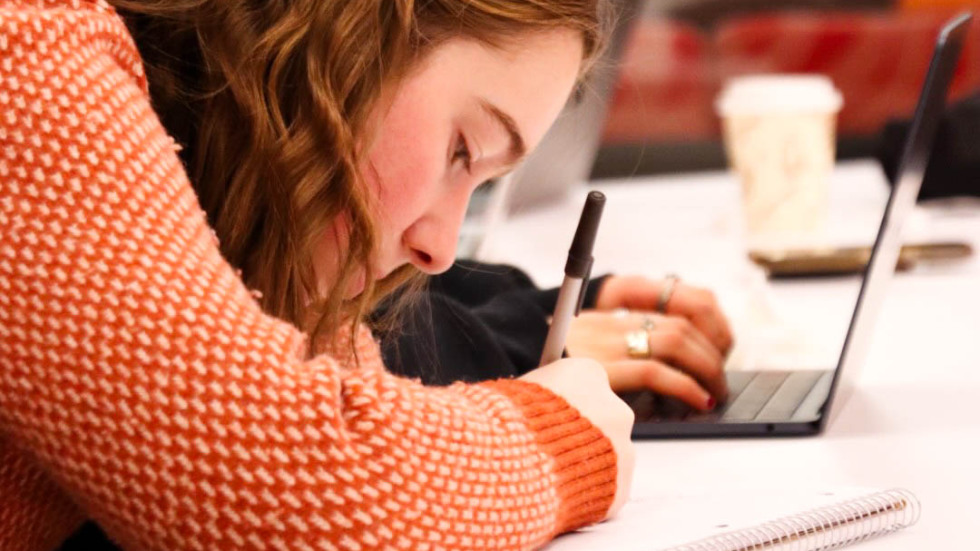 Audience member writing notes