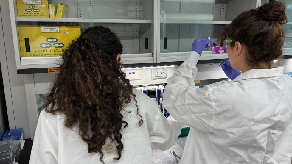 Kassalow and a lab partner conduct research