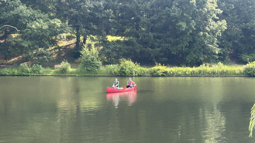two students in a canoe on a lake