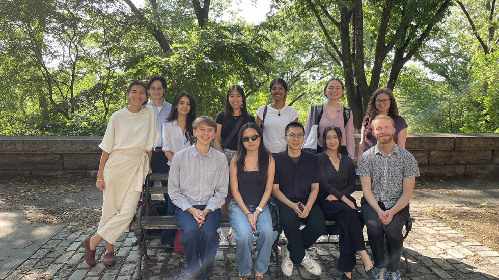 Griffin and colleagues pose on park bench in NYC