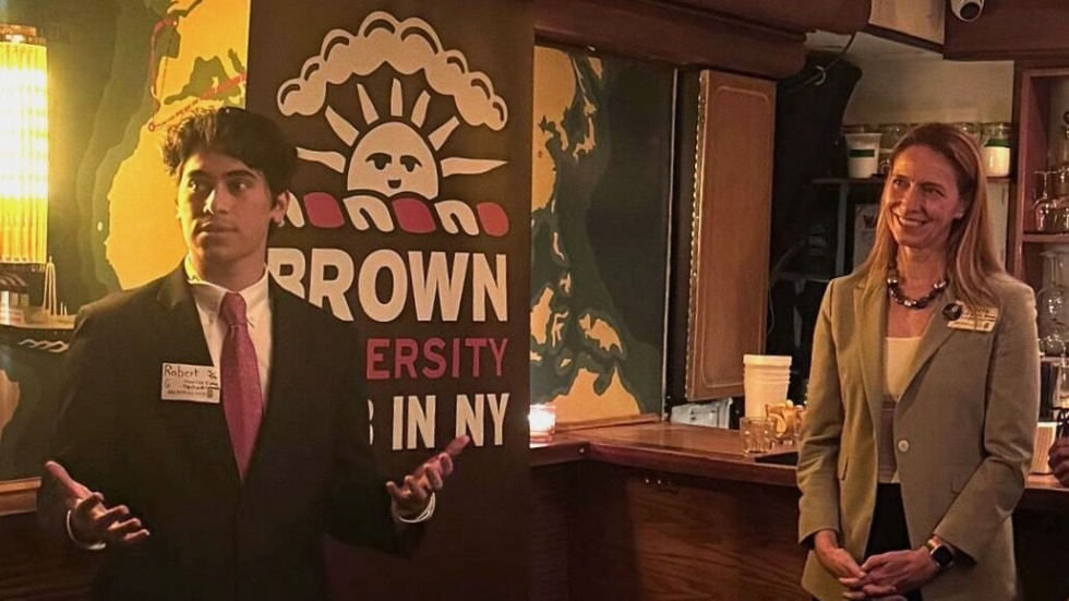 Kim and an alum speak to a crowd at Brown Club in NYC event