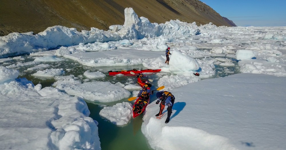 Team navigating ice chunks