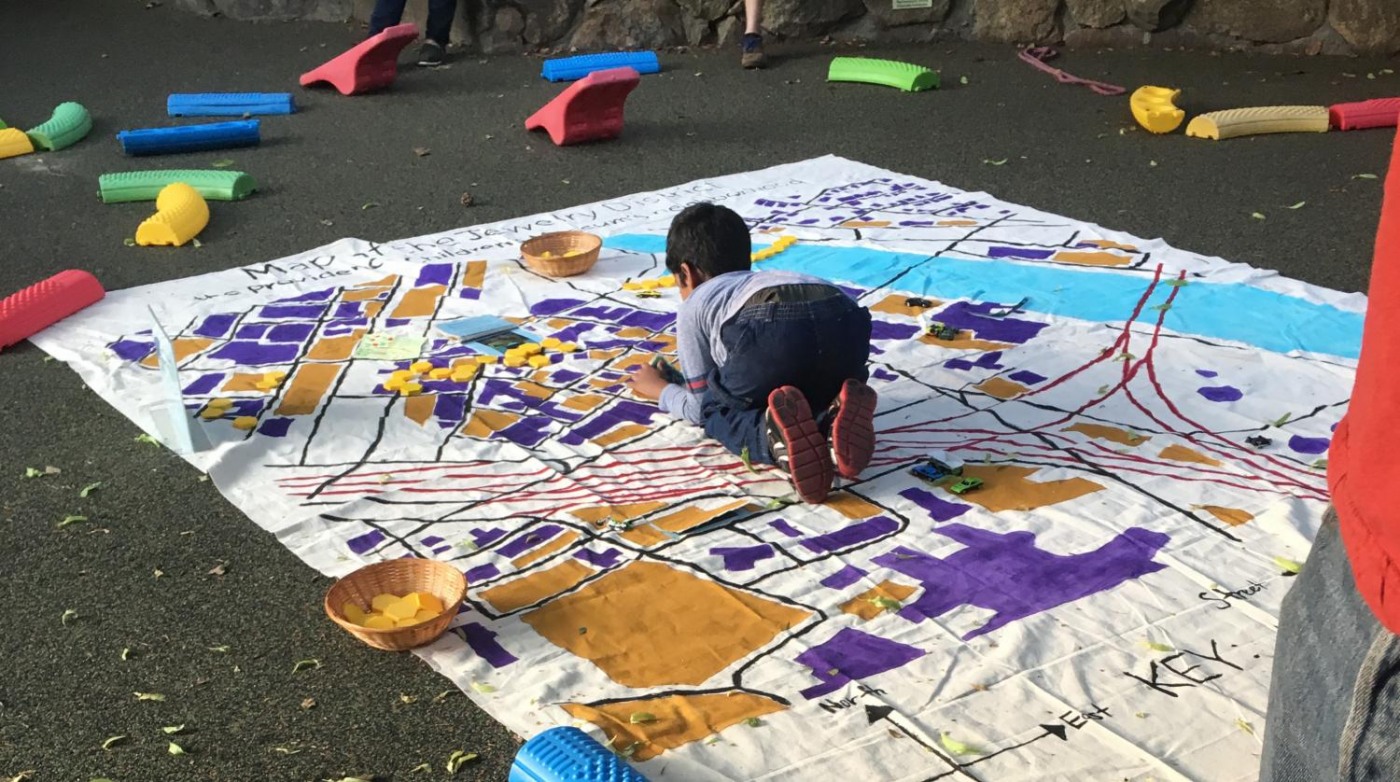 Child exploring map of neighborhood industrial sites